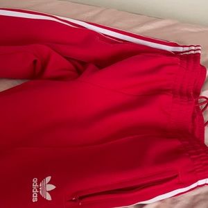 Red adidas strip pants